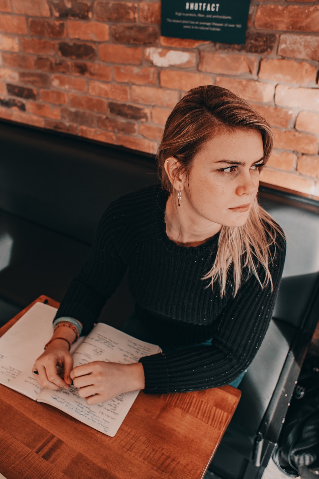 A lady sits in a cafe and thinks to herself